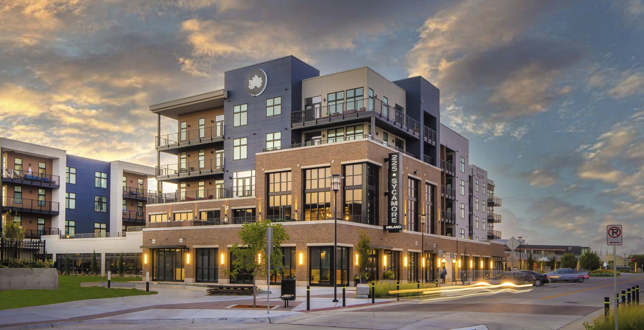 225 Sycamore apartments exterior shot of the apartment at dusk showing a modern apartment with a beautiful sky in the background